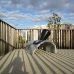 Frankfort Factory — Affordance, a white arched seat with a black backrest, on a Paris terrace